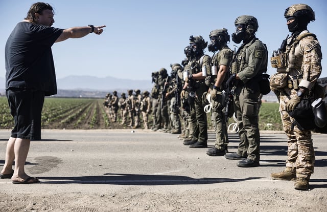 Federal agents block people protesting an ICE immigration raid at a nearby licensed cannabis farm on July 10, 2025 near Camarillo, California.