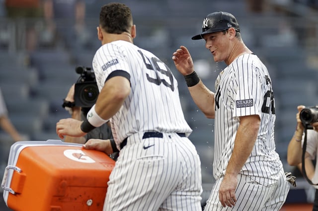 NEW YORK, NY - AUGUST 4: DJ LeMahieu #26 of the New York Yankees reacts after Aaron Judge #99 of the New York Yankees dumped water on him after hitting a walk-off single during the tenth inning against the Toronto Blue Jays at Yankee Stadium on August 4, 2024 in New York City. The Yankees won 4-3.