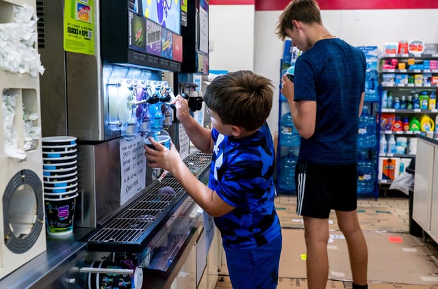 Aiden, left, and Conner McClister, right, get their Slurpees as part of Free Slurpee Day at the 7-Eleven in Fairless Hills, Pennsylvania on Thursday, July 11, 2024.