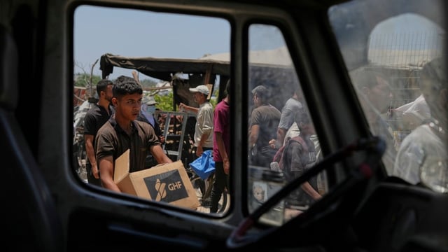 A Palestinian carries a box containing food and humanitarian aid delivered by the Gaza Humanitarian Foundation, a U.S.- and Israeli-backed organization, in Rafah on June 11.