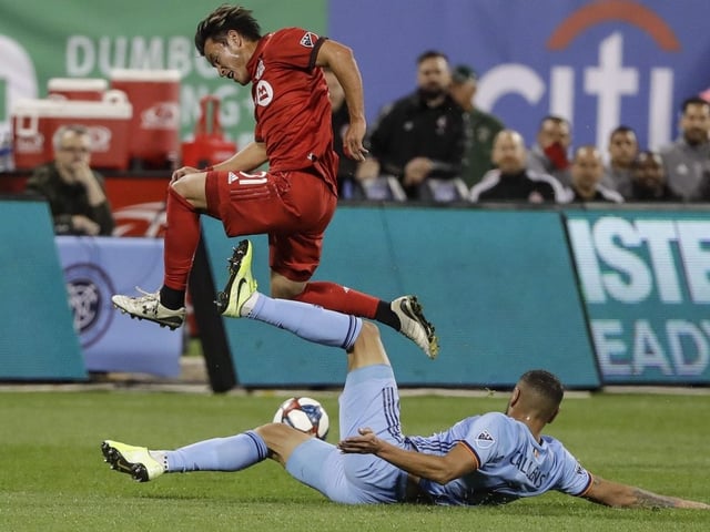 Toronto FC renews hostilities with Eastern Conference rival New York City FC on Sunday in the round of 16 at the MLS is Back Tournament. New York City FC's Alexander Callens, below, tries to tackle Toronto FC's Tsubasa Endoh during the first half of an MLS Eastern Conference semifinal soccer match in New York City, Wednesday, Oct. 23, 2019.