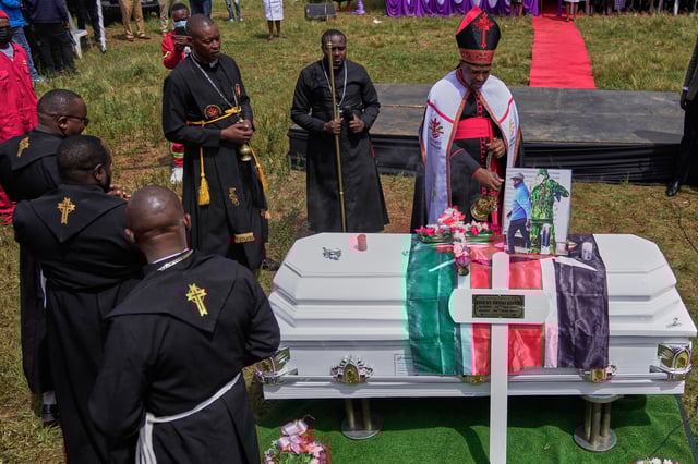 A priest blesses the casket of vendor Boniface Kariuki, who was shot at close range by a police officer, during last month's protests, in Kangema, Muranga County, Kenya, Friday, July 11, 2025. (AP Photo/Brian Inganga)