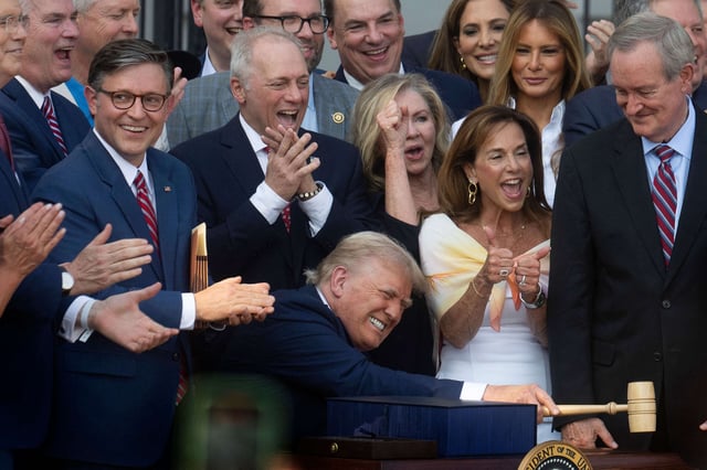President Donald Trump bangs a gavel after signing his signature bill of tax breaks and spending cuts on the South Lawn of the White House in Washington, D.C., on July 4, 2025.