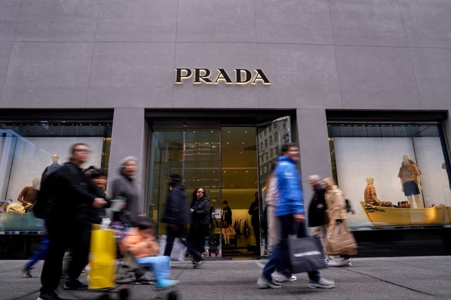 People walk past the store of Italian luxury fashion house Prada on 5th Avenue in New York City, U.S., May 23, 2025. REUTERS/Adam Gray/File Photo