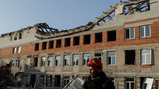 A firefighter works at the site of a building hit by a Russian drone strike, amid Russia's attack on Ukraine, in downtown Kharkv on Friday.  