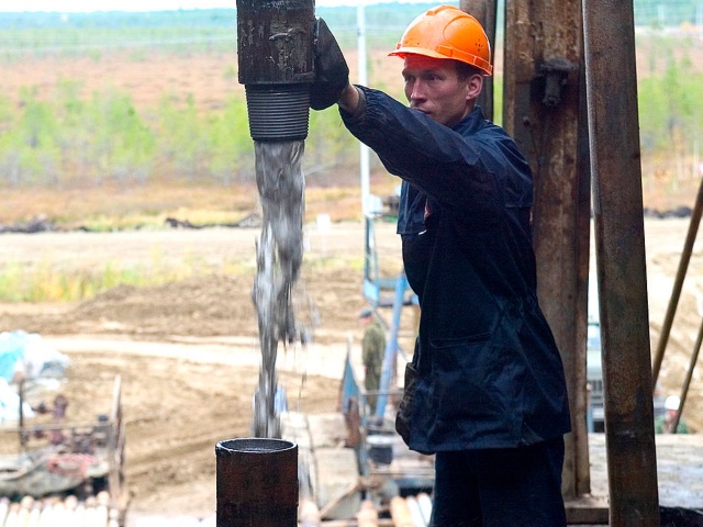 RUSSIA - SEPTEMBER 22: Bore fluid gushes from a well on an oil derrick in the Lukoil owned Ozernoje oil field in the Urals, Russia, Wednesday, September 22, 2004. ConocoPhillips, the third-largest U.S. oil company by sales, is set to pay at least $1.9 billion for the Russian government's remaining stake in OAO Lukoil, the nation's largest oil producer. (Photo by Dmitry Beliakov/Bloomberg via Getty Images)