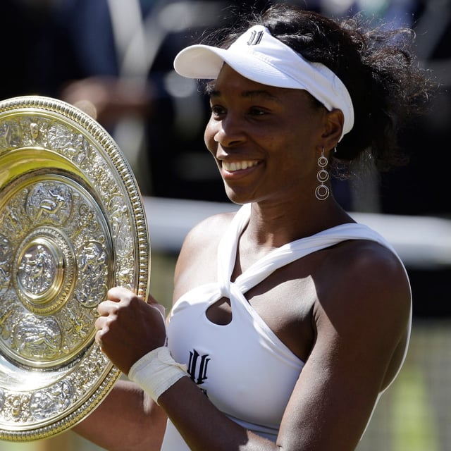 FILE - Venus Williams holds the trophy after defeating her sister Serena to win the Women's Singles Championship on the Centre Court at Wimbledon, Saturday, July 5, 2008. (AP Photo/Alastair Grant, File)