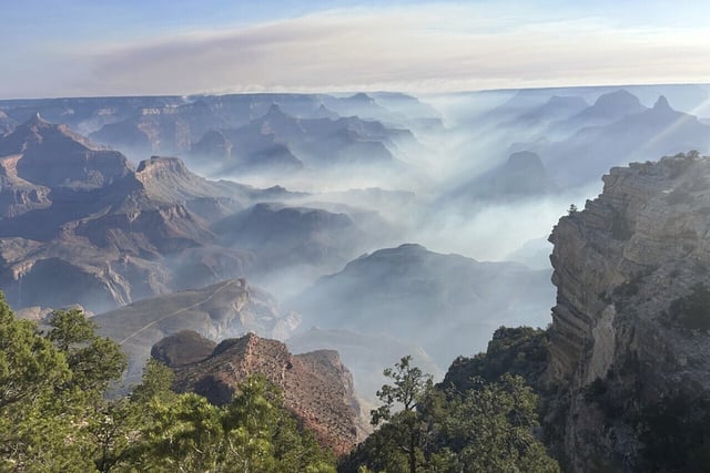 In this photo provided by the National Park Service, smoke from wildfires settles over Grand Canyon National Park in northern Arizona on Friday, July 11, 2025. 