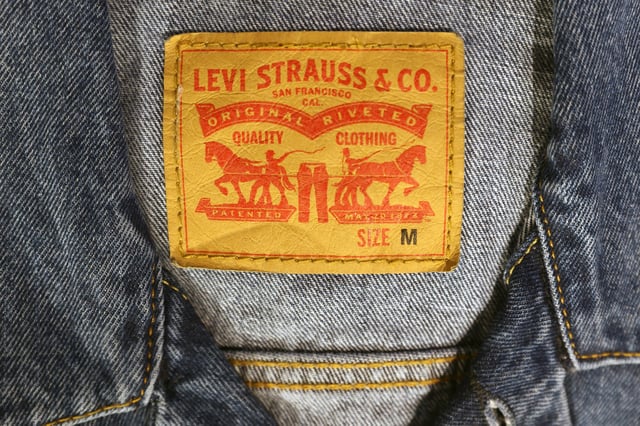 The Levi Strauss & Co. label is seen on clothes in a store at the Woodbury Common Premium Outlets in Central Valley, New York, U.S., February 15, 2022. REUTERS/Andrew Kelly/ File Photo