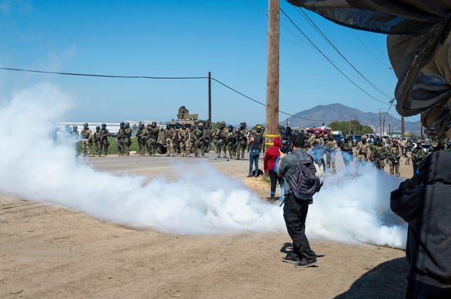 Federal immigration agents toss tear gas at protesters during a raid in the agriculture area of Camarillo, Calif., Thursday, July 10, 2025. (AP Photo/Michael Owen Baker)