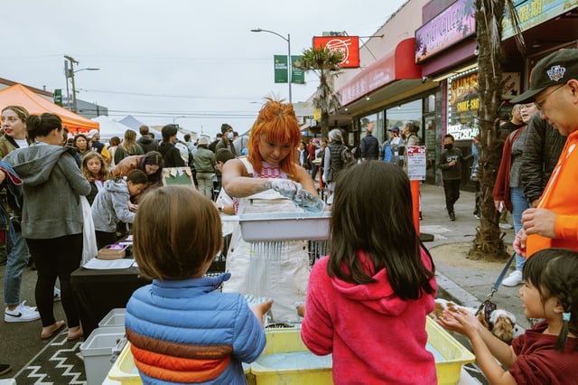 Messy Art Lab instructor Gabbie Vitala works with kids at the Night Market in the Sunset District in September 2023. There were two markets in 2024. This year there will be none but organizers say they will return in 2026.
