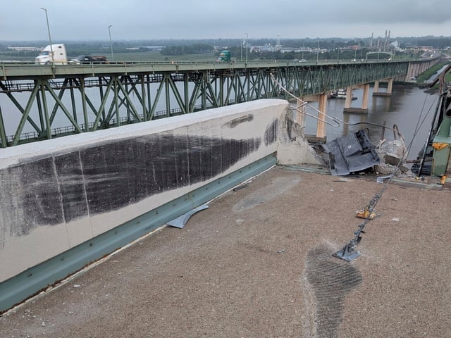 This photo provided by Delaware River and Bay Authority shows the scene where a tractor-trailer cab crashed through a concrete barrier and plunged off the Delaware Memorial Bridge into the Delaware River, between Delaware and New Jersey, on Friday, July 11, 2025. (Delaware River and Bay Authority via AP)