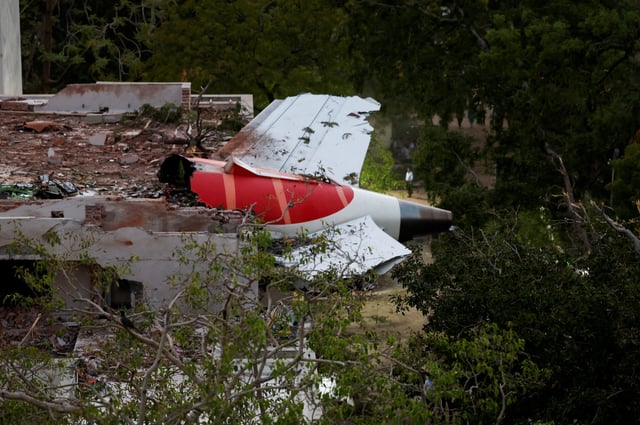 FILE PHOTO: Tail of an Air India Boeing 787 Dreamliner plane that crashed is seen stuck on a building after the incident in Ahmedabad, India, June 12, 2025. REUTERS/Amit Dave/File Photo