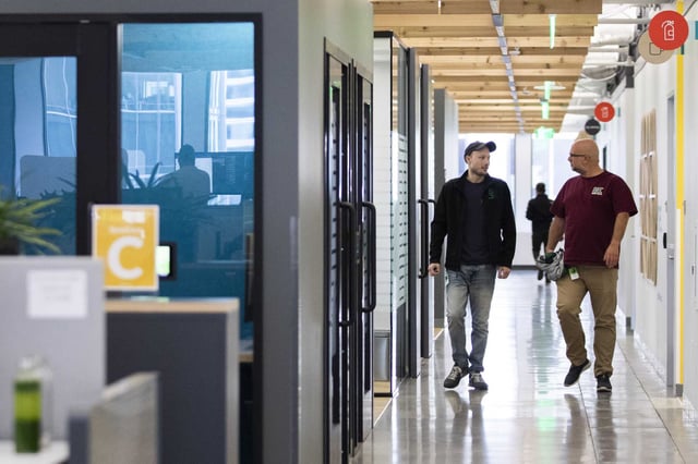 Employees chat while walking the halls of Glassdoor’s headquarters in San Francisco on April 26, 2022. Job platforms Indeed and Glassdoor will lay off 1,300 employees as parent company Recruit Holdings restructures operations and goes all in on AI.