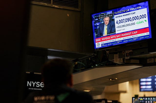 A screen displays news on "Nvidia hits $4T market cap" on the floor at the New York Stock Exchange (NYSE) in New York City, U.S., July 9, 2025.