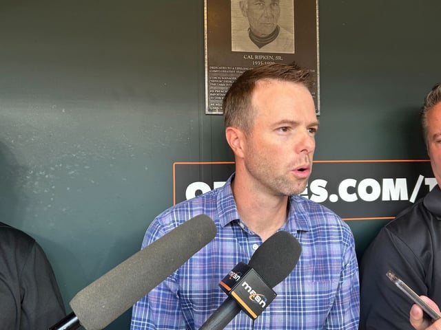 Matt Blood, who oversees the MLB draft for the Orioles, speaks with the media in Camden Yards’ home dugout ahead of Sunday’s first round. (Taylor Lyons/Staff)