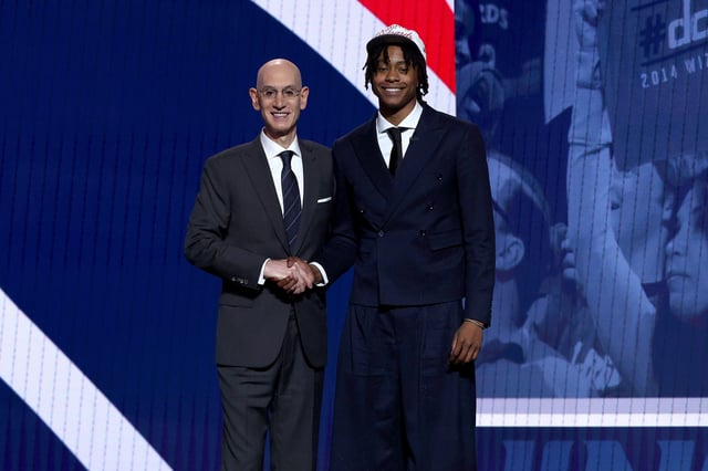 Tre Johnson (R) shakes hands with NBA commissioner Adam Silver (L) after being drafted sixth overall by the Washington Wizards during the first round of the 2025 NBA Draft at Barclays Center on June 25, 2025 in the Brooklyn borough of New York City.