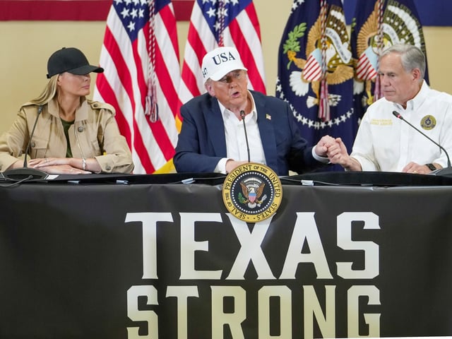 President Donald J. Trump, center, first lady Melania Trump and Texas Gov. Greg Abbott, attend a roundtable discussion at the Community Emergency Operations Center in Kerrville, Texas, Friday, July 11, 2025.  (Ricardo B. Brazziell/Austin American-Statesman via AP)