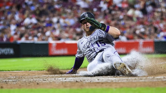 Jul 11, 2025; Cincinnati, Ohio, USA; Colorado Rockies catcher Hunter Goodman (15) scores on a wild pitch by Cincinnati Reds pitcher Tony Santillan (not pictured) in the eighth inning at Great American Ball Park. Mandatory Credit: Katie Stratman-Imagn Images