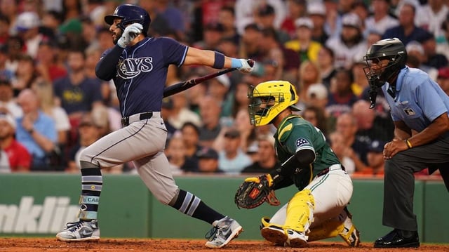 Jul 11, 2025; Boston, Massachusetts, USA; Tampa Bay Rays second base José Caballero (77) gets to first base on a fielding error against the Boston Red Sox in the third inning at Fenway Park. Mandatory Credit: David Butler II-Imagn Images