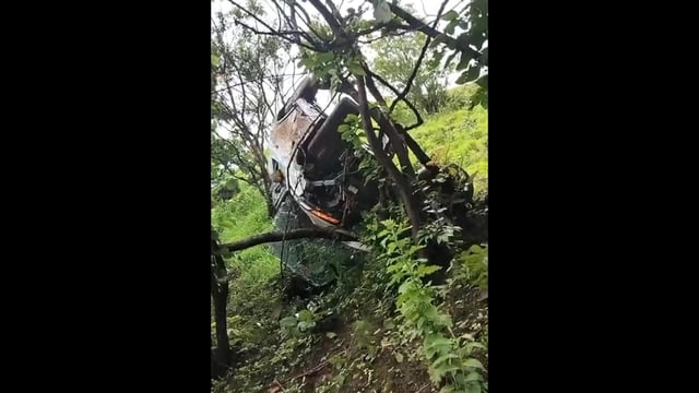 The video captures the harrowing moment the car, driven on a steep, grass-covered slope, loses control and slips into the deep ditch (Video grab)