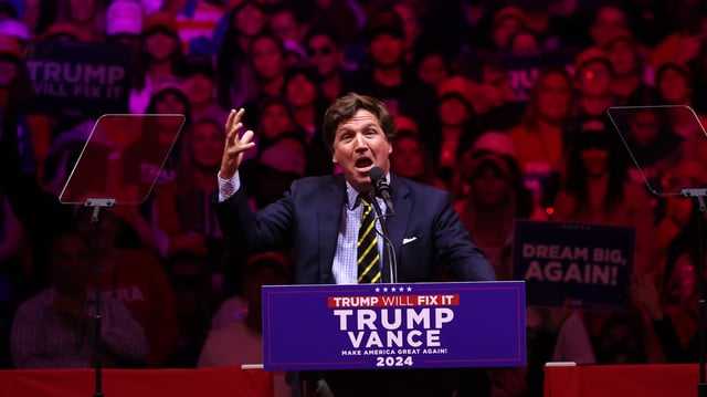 NEW YORK, NEW YORK - OCTOBER 27: Political commentator Tucker Carlson speaks before Republican presidential nominee, former U.S. President Donald Trump takes the stage during a campaign rally at Madison Square Garden on October 27, 2024 in New York City. Trump closed out his weekend of campaigning in NYC with a guest list of speakers that includes his running mate Republican Vice Presidential nominee, U.S. Sen. J.D. Vance (R-OH), Tesla CEO Elon Musk, UFC CEO Dana White, and House Speaker Mike Johnson, among others, nine days before Election Day.  (Photo by Michael M. Santiago/Getty Images)