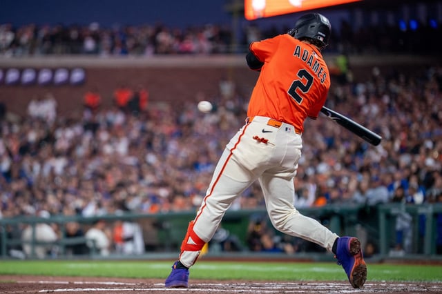 Jul 11, 2025; San Francisco, California, USA; San Francisco Giants shortstop Willy Adames (2) hits a two run triple against the Los Angeles Dodgers during the fifth inning at Oracle Park. Neville E. Guard-Imagn Images