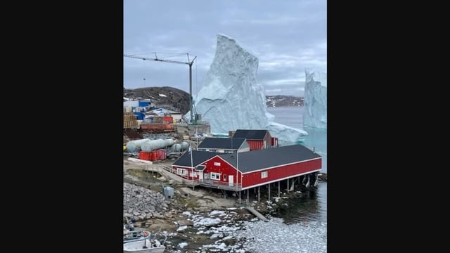 A mammoth iceberg is drifting towards a village in Greenland. 
