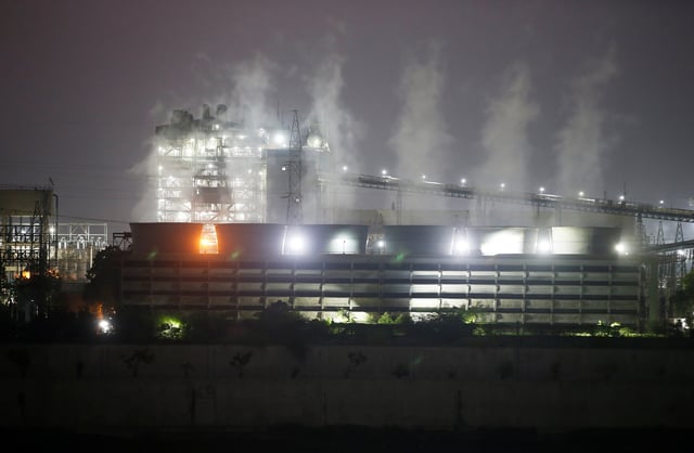 Smoke billows from the cooling towers of a coal-fired power plant in Ahmedabad, India, October 13, 2021. REUTERS/Amit Dave/File Photo