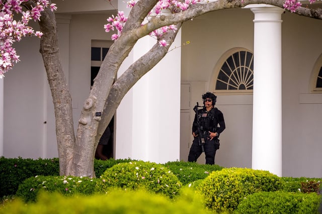 A member of the Secret Service Counter Assault Team stands along the colonnade before President Donald Trump departs the White House on March 28, in Washington, DC.
