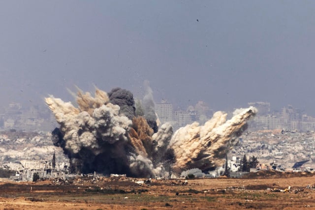 Smoke and debris rises following an Israeli airstrike in northern Gaza near Beit Hanoun on Thursday.