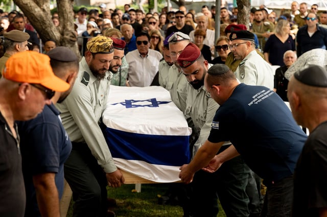 HAIFA, ISRAEL - JULY 8: Israeli soldiers carry a coffin covered with Israeli flag during a funeral for Sgt. First Class Benyamin Asulin on July 8, 2025 in Haifa, Israel. Asulin was one of five Israeli soldiers killed in Beit Hanoun, in the northern Gaza Strip, last night when they were hit by a roadside bomb while patrolling on foot. (Photo by Amir Levy/Getty Images)