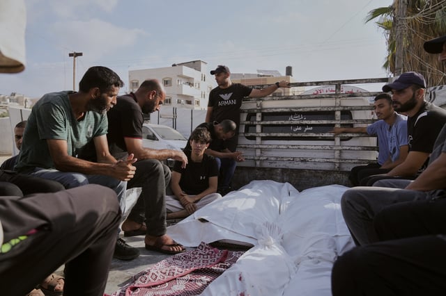 Mourners attend the funeral of their relatives who were killed in an Israeli bombardment, in Deir al-Balah, Gaza Strip, Saturday, July 12, 2025. (AP Photo/Abdel Kareem Hana)