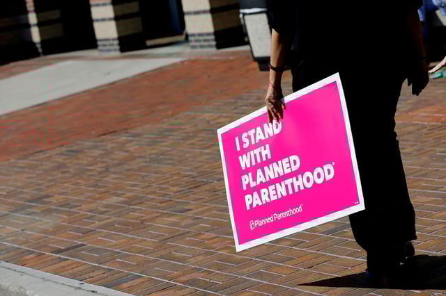 A sign in support of Planned Parenthood is seen outside a town hall meeting for Republican U.S. Senator Bill Cassidy in Metairie, Louisiana, U.S. February 22, 2017. REUTERS/Jonathan Bachman/File Photo