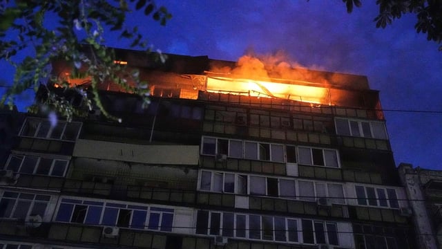A fire burns at a residential building after a Russian attack in Kyiv on Thursday.
