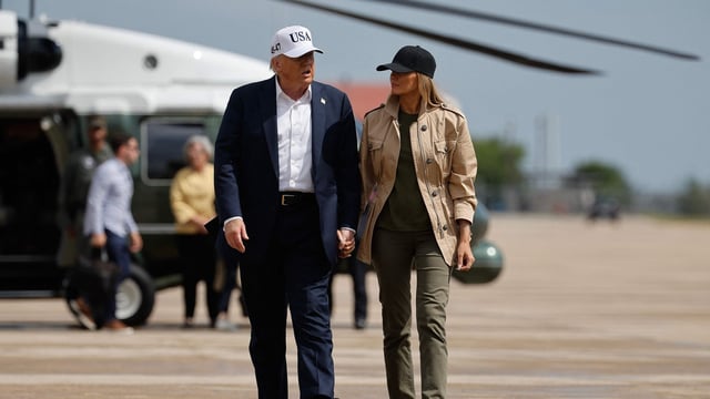 President Donald Trump and first lady Melania Trump visit walk across the tarmac at Lackland Air Force Base after meeting with state and local leaders, first responders and victims of last week's flash flooding on July 11, 2025 in San Antonio, Texas. 