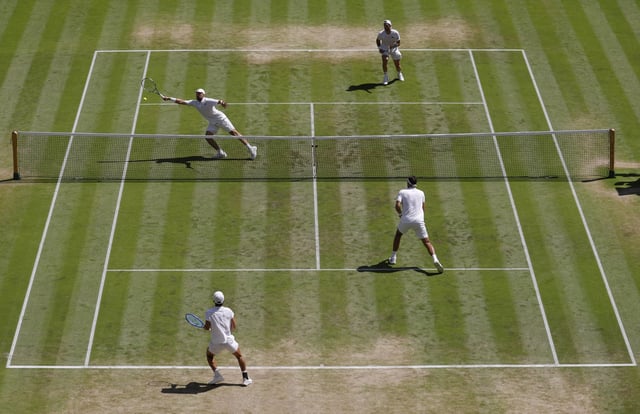Tennis - Wimbledon - All England Lawn Tennis and Croquet Club, London, Britain - July 12, 2025 Britain's Lloyd Glasspool and Julian Cash in action during the men's doubles final against Australia's Rinky Hijikata and Netherlands' David Pel REUTERS/Andrew Couldridge