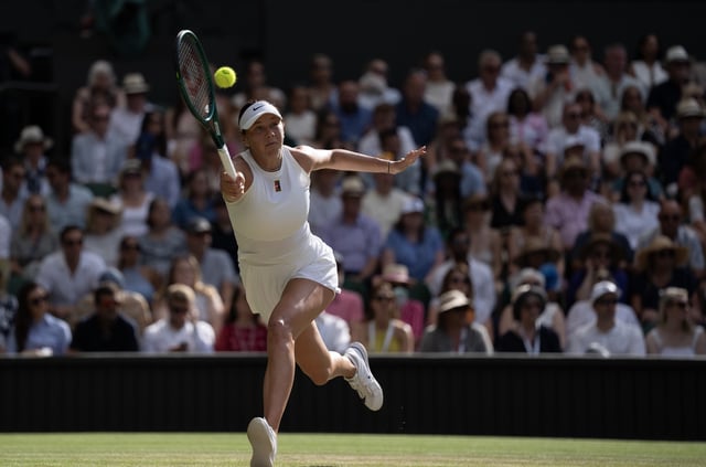 Jul 12, 2025; Wimbledon, United Kingdom; Amanda Anisimova of the United States returns a shot during the women’s final match against Iga Swiatek of Poland on day 13 at All England Lawn Tennis and Croquet Club. Mandatory Credit: Susan Mullane-Imagn Images
