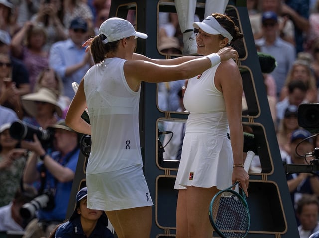 Jul 12, 2025; Wimbledon, United Kingdom; Iga Swiatek of Poland and Amanda Anisimova of the United States at the net after the women’s singles final on day 13 at All England Lawn Tennis and Croquet Club. Mandatory Credit: Susan Mullane-Imagn Images