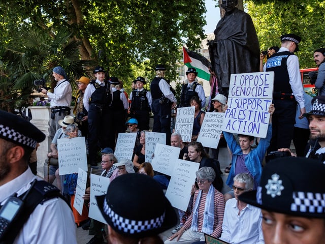 LONDON, UNITED KINGDOM - JULY 12: Metropolitan Police officers surround a demonstration against Palestine Action's proscription as a terrorist organisation, before arresting the in Parliament Square on July 12, 2025 in London, England. This protest is the second held by pro-Palestinian groups since the UK Parliament's decision to proscribe Palestine Action as a terror group. Yesterday, the UN Human Rights Office announced that 798 people have been killed while trying to access aid in Gaza since the end of May. (Photo by Dan Kitwood/Getty Images)