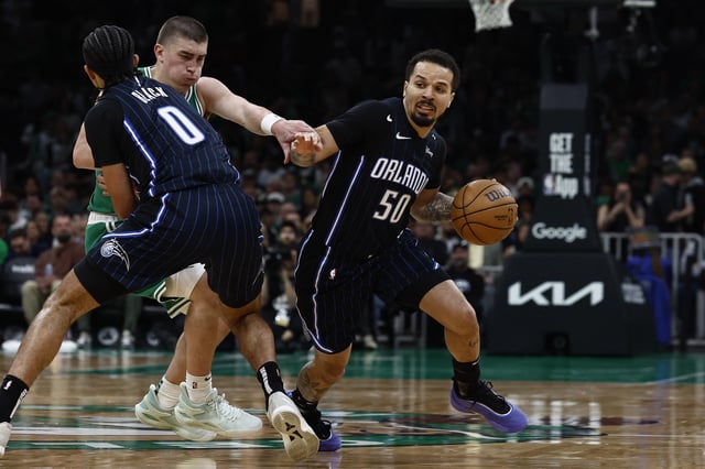 Apr 23, 2025; Boston, Massachusetts, USA; Orlando Magic guard Cole Anthony (50) goes around a pick set by guard Anthony Black (0) on Boston Celtics guard Payton Pritchard (11) during the second quarter of game two of the first round of the 2024 NBA Playoffs at TD Garden. Winslow Townson-Imagn Images/File Photo