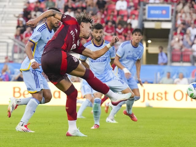 Toronto FC's Theo Corbeanu (front) takes a shot on goal as Atlanta United's defence looks on during first half MLS action in Toronto, on Saturday, July 12, 2025.