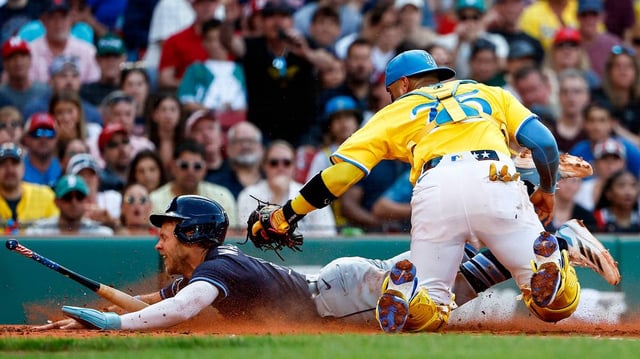 The Tampa Bay Rays’ Taylor Walls slides into a bat after he was tagged out at home by Boston Red Sox catcher Carlos Narvaez (75) on a safety squeeze play during the sixth inning at Fenway Park on Saturday, July 12, 2025, in Boston. (Winslow Townson/Getty Images/TNS)