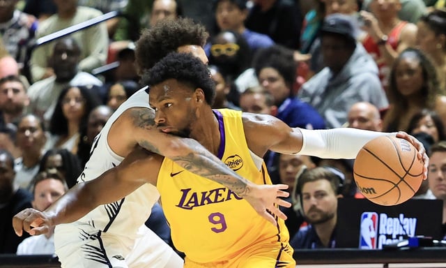 Lakers guard Bronny James is fouled by the New Orleans Pelicans’ Lester Quinones during the first half of an NBA Summer League game on Saturday night in Las Vegas. (Photo by Ethan Miller/Getty Images)