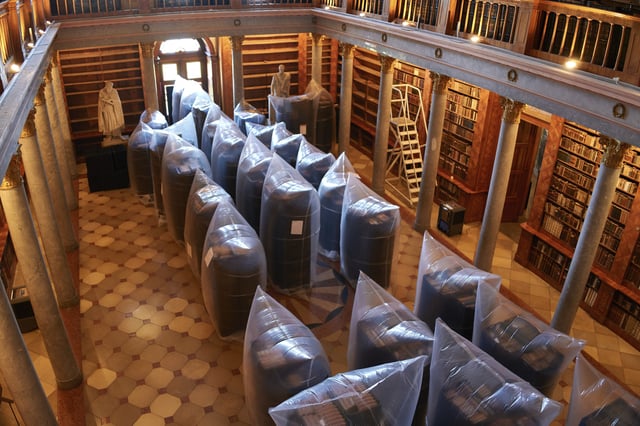 Books are kept in hermetically sealed plastic sacks for disinfection, at the Pannonhalma Archabbey's library in Pannonhalma, Hungary, Thursday, July 3, 2025, as a beetle infestation threatens its ancient collection. (AP Photo/Bela Szandelszky)