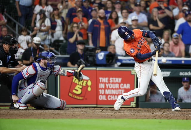 Jul 12, 2025; Houston, Texas, USA; Houston Astros third baseman Zack Short (38) hits the game winning hit against the Texas Rangers in the 11th inning at Daikin Park.  Thomas Shea-Imagn Image