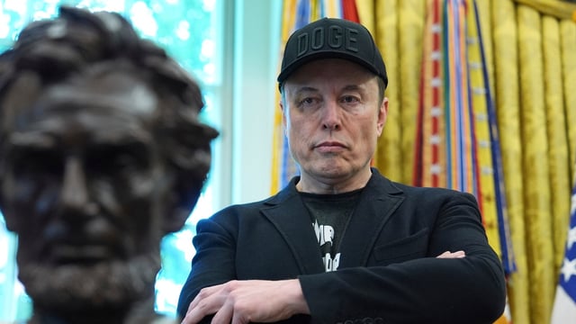 Elon Musk listens as President Donald Trump speaks during a news conference in the Oval Office of the White House, May 30, 2025, in Washington. (AP Photo/Evan Vucci, File)