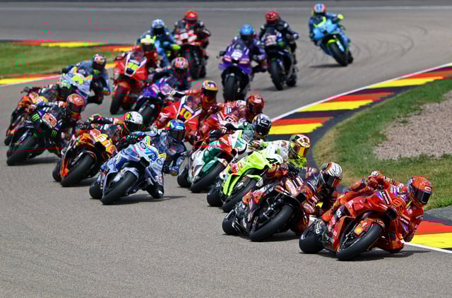 MotoGP - German Grand Prix - Sachsenring, Hohenstein-Ernstthal, Germany - July 13, 2025 Ducati Lenovo Team's Marc Marquez and BK8 Gresini Racing MotoGP's Alex Marquez in action with riders during the race REUTERS/Lisi Niesner
