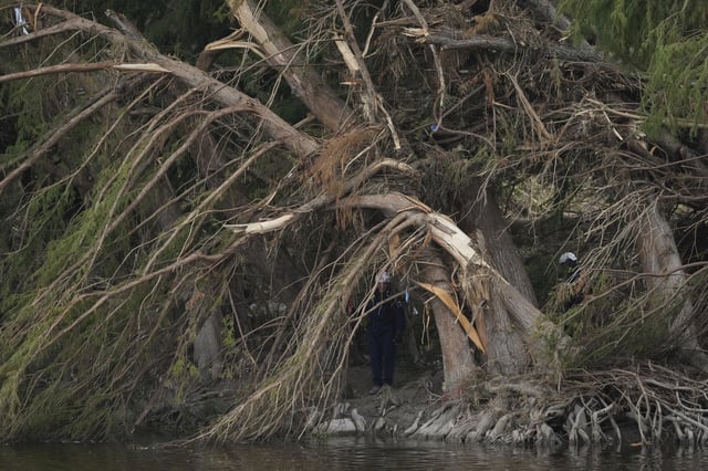 Search and rescue teams comb the banks of the Guadalupe River after a flash flood swept through the area, Saturday, July 12, 2025, in Kerrville, Texas. (AP Photo/Eric Gay)
