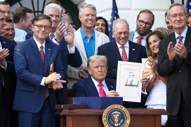 WASHINGTON, DC - JULY 04: U.S. President Donald Trump, joined by Republican lawmakers, signs the One, Big Beautiful Bill Act into law during an Independence Day military family picnic on the South Lawn of the White House on July 04, 2025 in Washington, DC. After weeks of negotiations with Republican holdouts Congress passed the One, Big Beautiful Bill Act into law, President Trump’s signature tax and spending bill. The bill makes permanent President Donald Trump’s 2017 tax cuts, increase spending on defense and immigration enforcement and temporarily cut taxes on tips, while cutting funding for Medicaid, food assistance and other social safety net programs. (Photo by Samuel Corum/Getty Images)